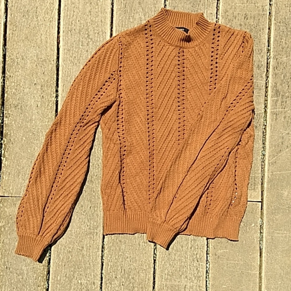 Orange knit sweater with bell sleeves